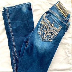 Dark denim Rock Revival Mid-rise boot cut jeans.